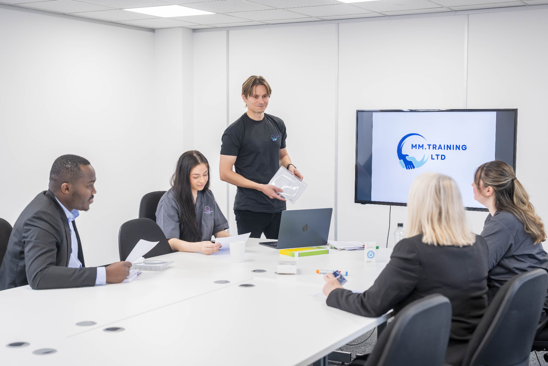 Delegates in an MMTraining classroom session around the table