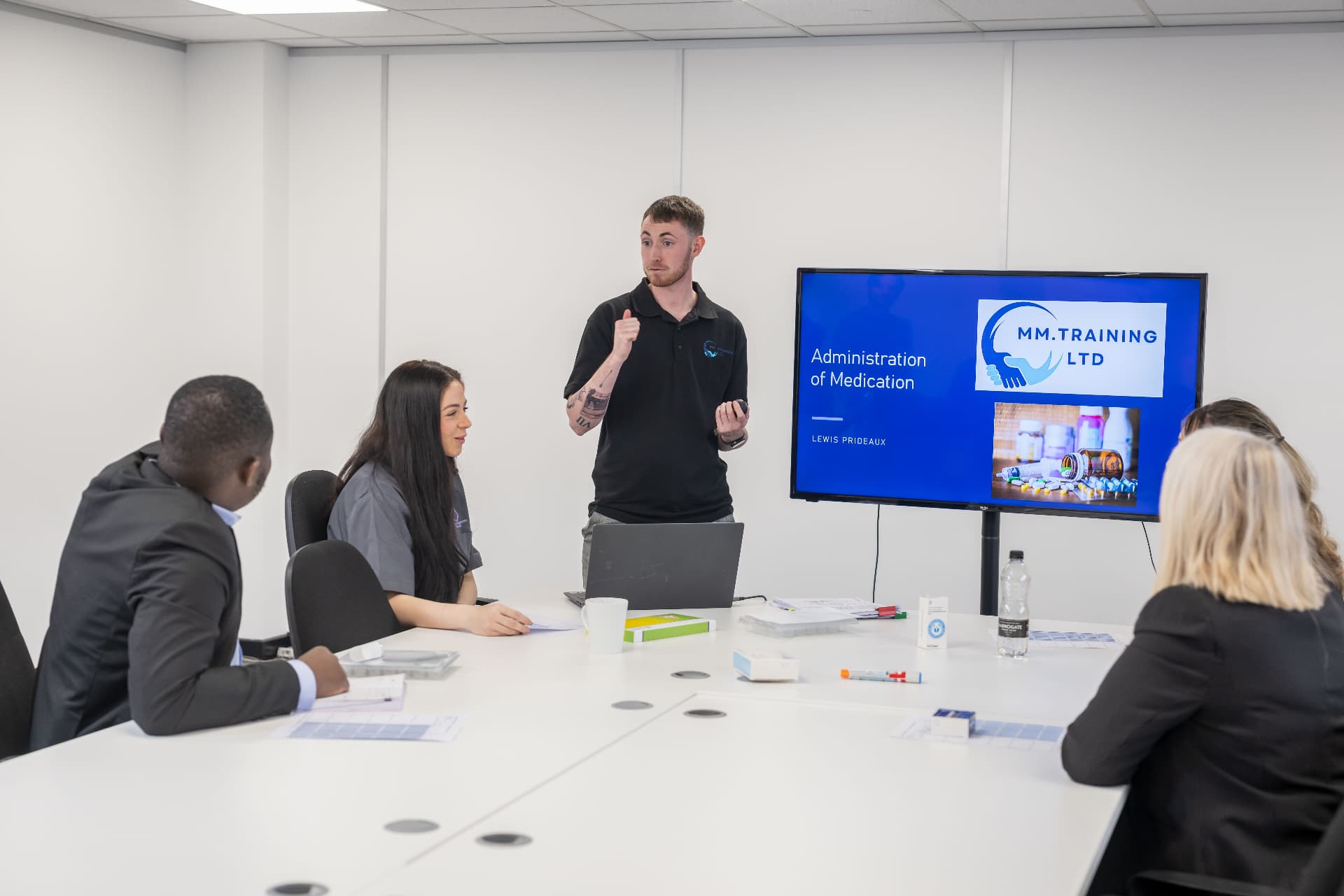 Trainer delivering an administration of medication session to a group