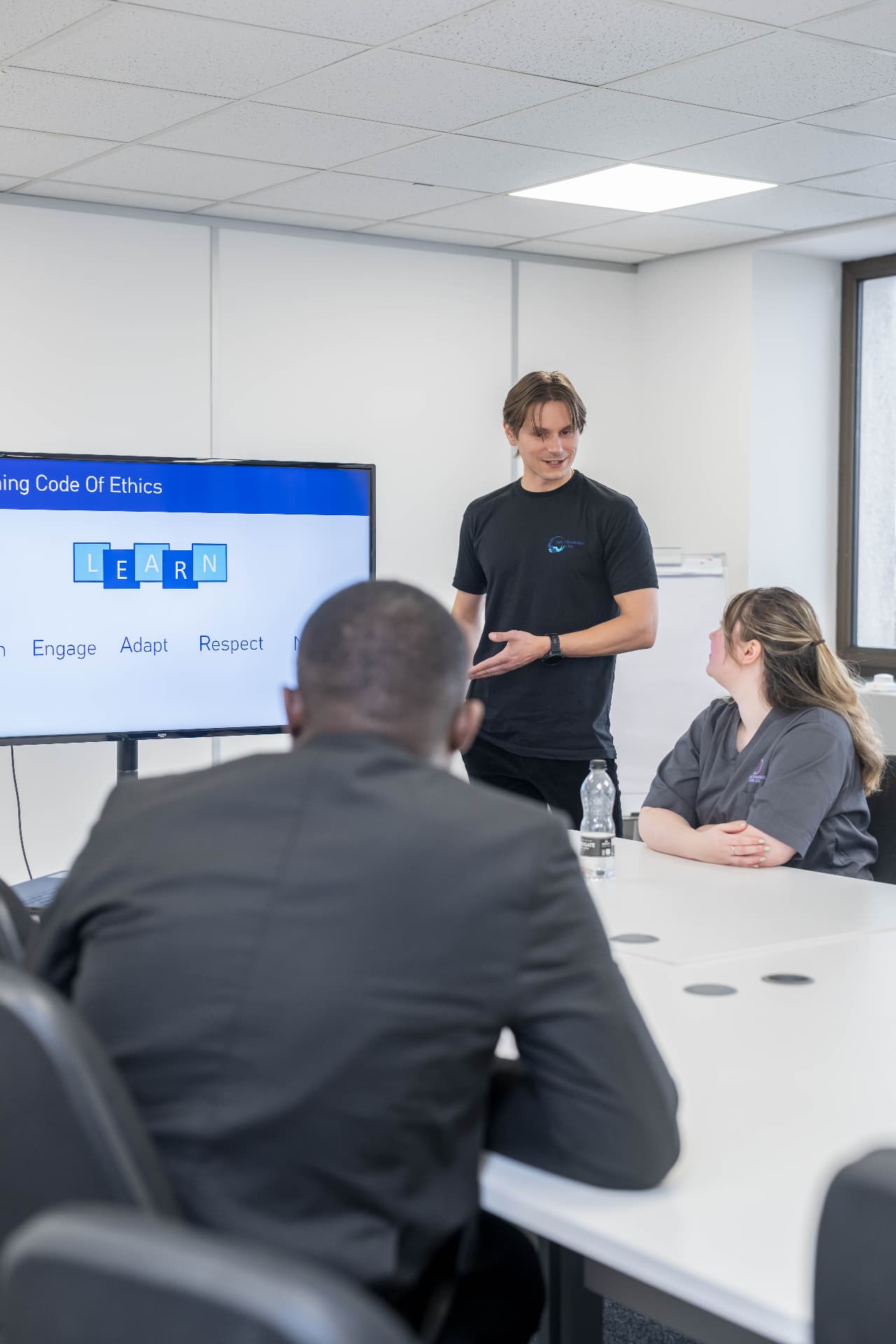 An MMTraining trainer leading a discussion with a small group in a classroom session