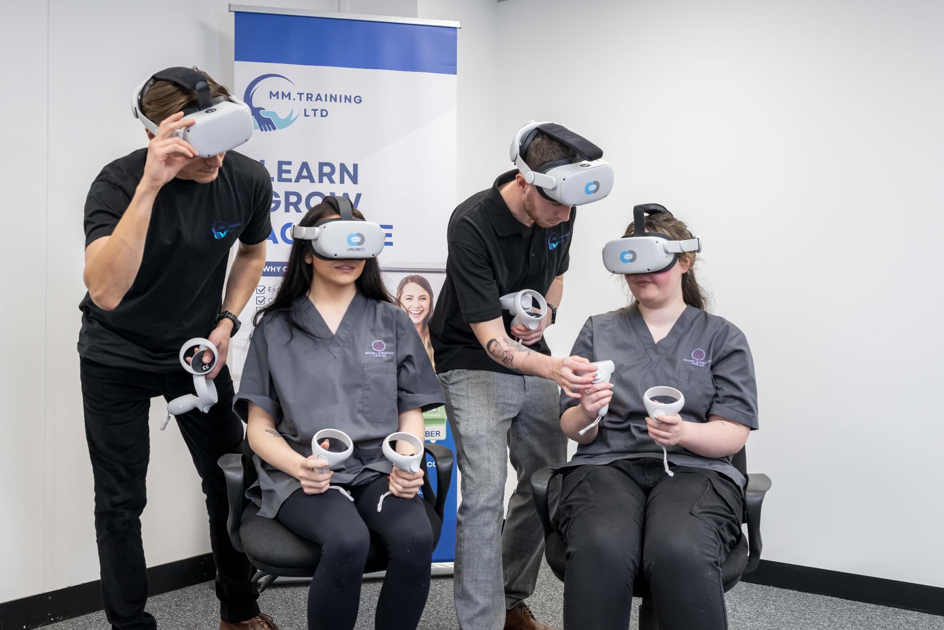 MMTraining trainers helping delegates use VR headsets during a dementia training session